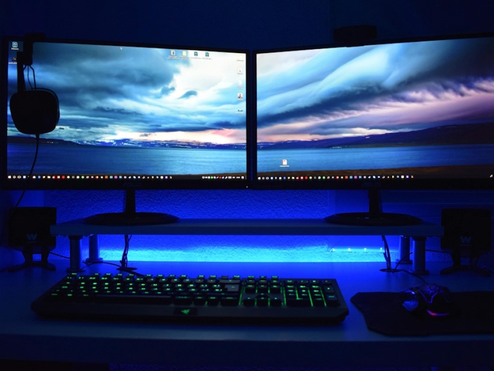 Dual monitor computer setup with blue lighting representing affordable website design for Hawaii businesses
