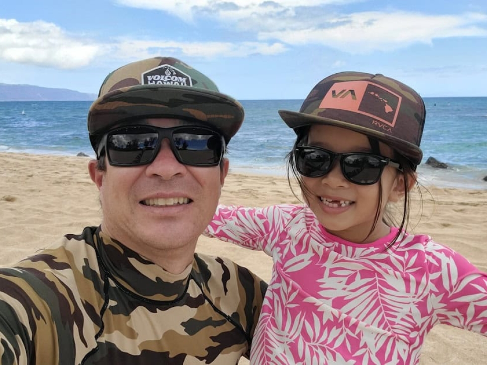 Father and daughter web design team in Hawaii, Clean Design Launch founders Cheyne and Marlie Settlemire smiling at the beach.