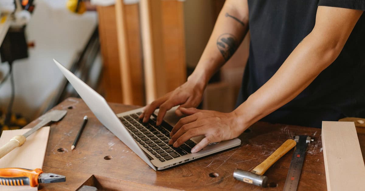 Person using laptop to set up a Bluehost account for their small business website.