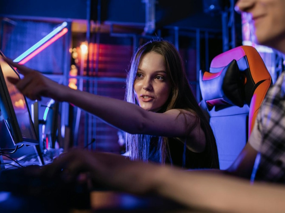 Young woman pointing at a computer screen in a modern workspace representing the Hawaii web design process