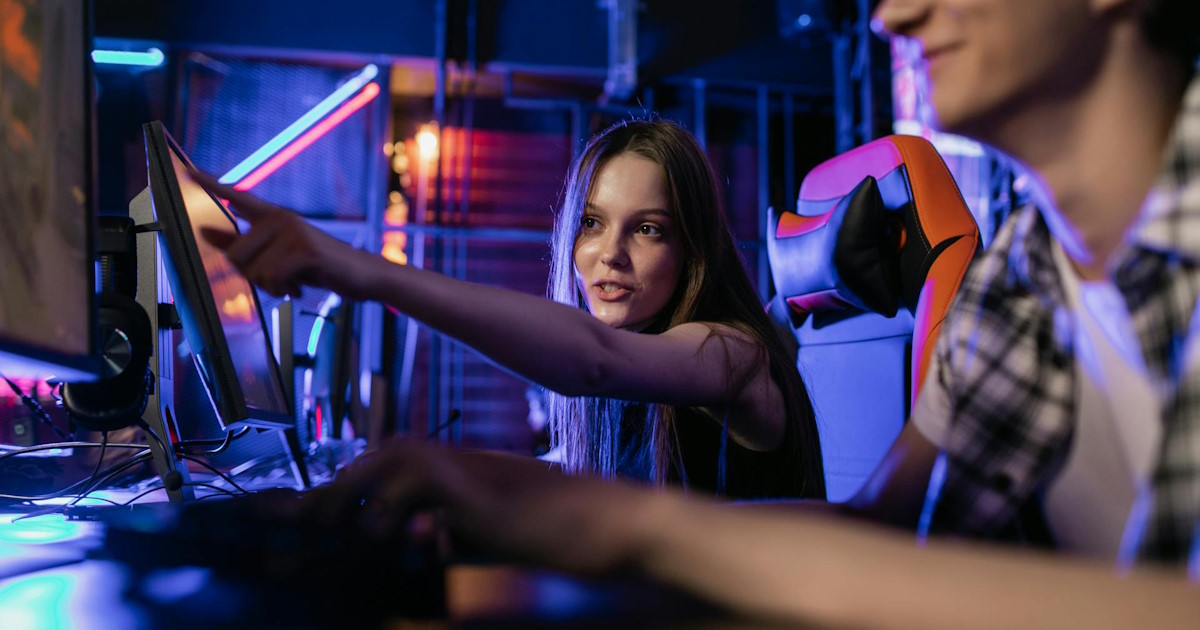 Young woman pointing at a computer screen in a modern workspace representing the Hawaii web design process