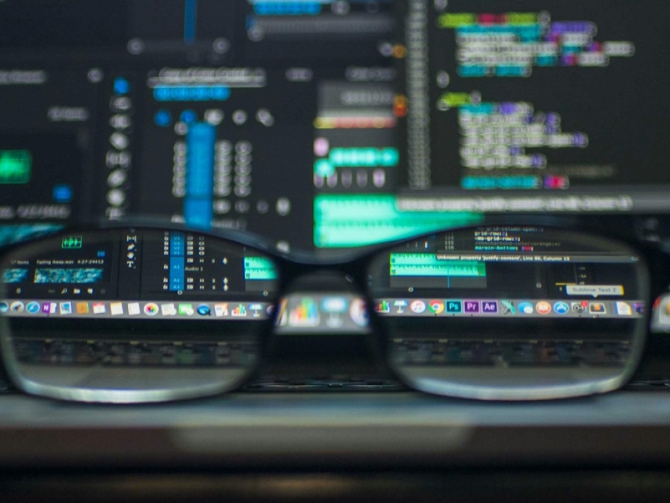 Blurred computer code seen through eyeglasses representing website performance issues