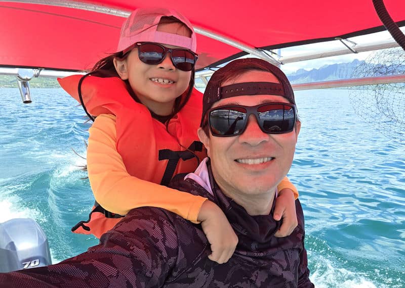 Marlie and Cheyne, the daughter-father web developer duo behind Clean Design Launch, smiling on our fishing boat in the ocean of Kaneohe Bay on Oahu, Hawaii.